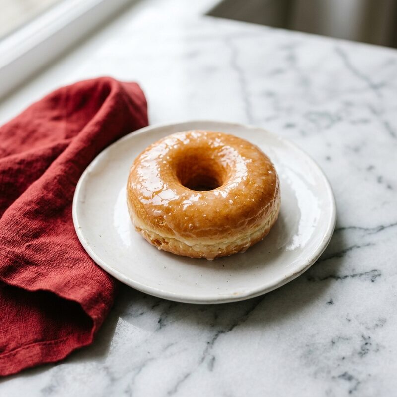 A tray of freshly glazed doughnuts